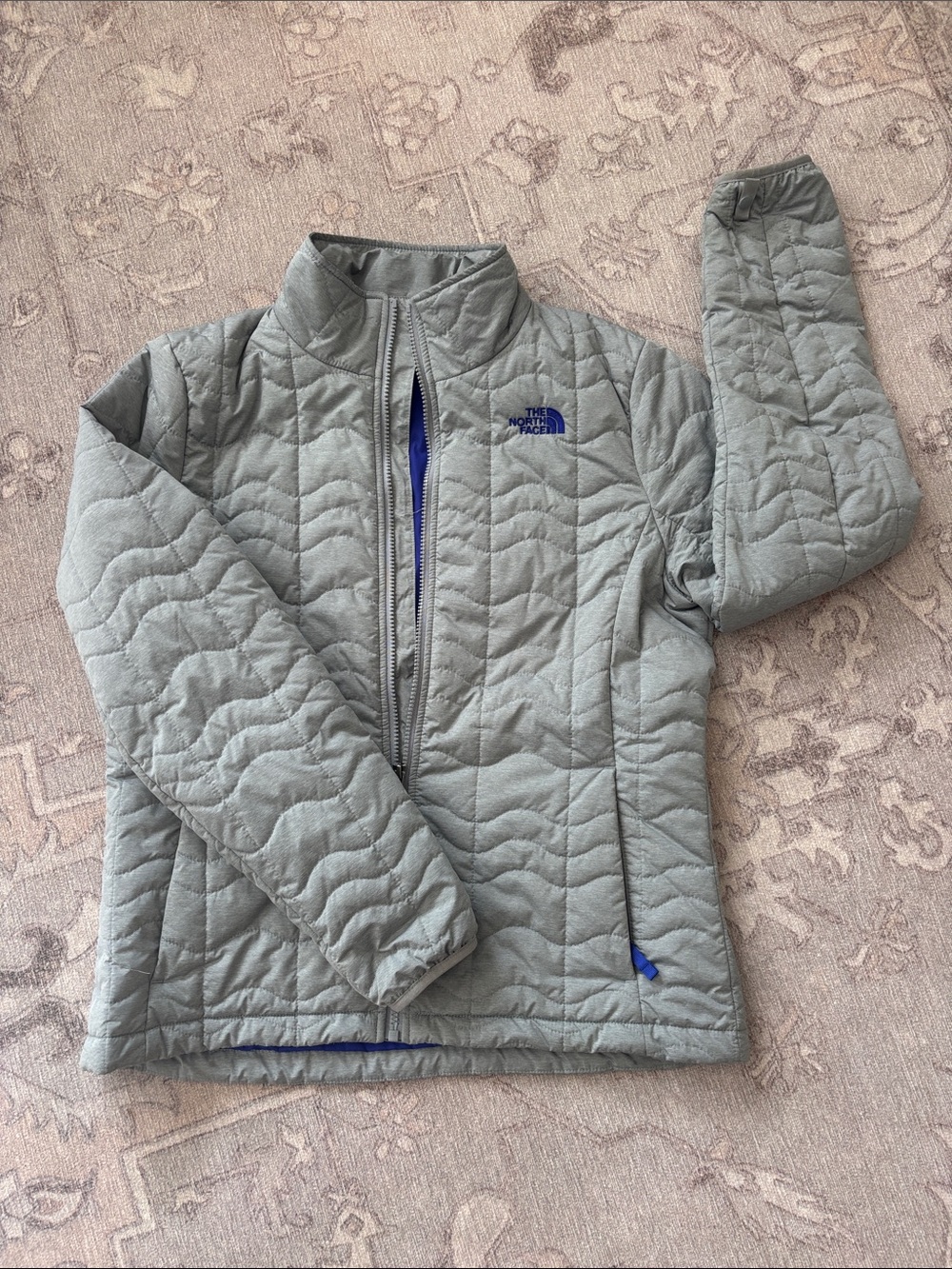 The North Face Women’s Light Gray Quilted Puffer Jacket with Purple Logo